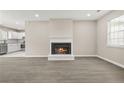 Bright living room featuring a fireplace, neutral walls, hardwood flooring, and open-concept design at 1158 Crystal Lake Rd, Atlanta, GA 30349