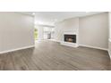 Inviting living room with modern flooring, cozy fireplace, and a seamless flow into the kitchen at 1158 Crystal Lake Rd, Atlanta, GA 30349