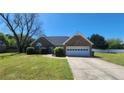Well-maintained brick home featuring an attached garage, lush lawn, and mature landscaping at 116 Ridge Xing, Temple, GA 30179
