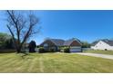 Charming brick home featuring an attached garage, manicured lawn, and well-maintained landscaping at 116 Ridge Xing, Temple, GA 30179