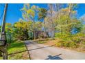 Charming two-story brick home with a long driveway surrounded by lush trees and greenery at 4510 Trumble Ter, Snellville, GA 30039