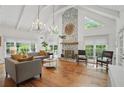 Bright living room with stone fireplace, vaulted ceilings, and hardwood floors at 7000 Hunters Knl, Atlanta, GA 30328