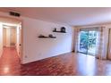 Well-lit living room with hardwood floors and glass sliding doors that open to a private balcony at 1181 Church St # D, Decatur, GA 30030
