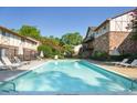 Inviting community pool surrounded by lounge chairs, landscaping, and multi-story residential buildings under a sunny sky at 1181 Church St # D, Decatur, GA 30030