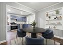 Open dining area flowing into a kitchen with stainless appliances and painted cabinets at 1870 Oak Valley Rd, Decatur, GA 30035
