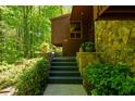 Exterior steps lead to the front entrance, surrounded by greenery and featuring stone accents at 2208 Guinevere Ne Way, Atlanta, GA 30345