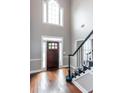 Grand foyer with high ceilings, hardwood floors, and staircase with white trim at 3011 Oak Hampton Ct, Duluth, GA 30096
