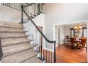 View of carpeted staircase leading to the second floor; hardwood floor visible at 3011 Oak Hampton Ct, Duluth, GA 30096