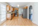 Bright kitchen featuring wood cabinets, stainless steel appliances, and tile backsplash at 4357 James Wade Dr, Snellville, GA 30039