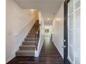Welcoming entryway with hardwood floors, a staircase leading to the upper level, and ample natural light at 8475 Douglass Trl, Jonesboro, GA 30236