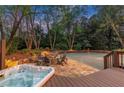 Backyard with stone fire pit area and hot tub, great for relaxation and outdoor entertainment at 3749 Watkins Ne Pl, Brookhaven, GA 30319