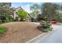 Brick home exterior with a three car garage, manicured lawn and plantings in a desirable suburban neighborhood at 3749 Watkins Ne Pl, Brookhaven, GA 30319