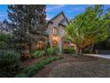 Elegant brick home with manicured landscaping, mature trees, and a welcoming entrance at 3749 Watkins Ne Pl, Brookhaven, GA 30319