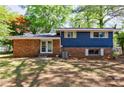 The rear exterior of a two-story brick and siding home featuring a spacious yard at 5287 Chantilly Ter, Atlanta, GA 30349