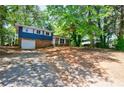 A two-story brick and siding home with a large front yard and driveway at 5287 Chantilly Ter, Atlanta, GA 30349