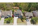 Aerial shot of a two-story home, manicured lawn, long driveway, and neighborhood setting at 68 Highcrest Dr, Acworth, GA 30101