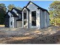 Stately two-story home showcasing a modern design with contrasting black and white brick and a two-car garage at 876 Bramlett Shoals Rd, Lawrenceville, GA 30045