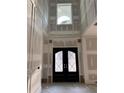 Grand foyer features a soaring ceiling, beautiful front door and decorative paneling at 876 Bramlett Shoals Rd, Lawrenceville, GA 30045