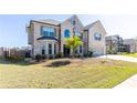 Attractive two-story brick home with bay windows and a well-maintained lawn, offering classic charm at 3728 In Bloom Way, Auburn, GA 30011