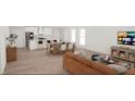 Spacious open concept living space with adjacent kitchen and dining areas and large screen tv at 95 Rome St, Temple, GA 30179