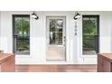 Front entrance featuring a glass door, black window trim, and exterior sconce lighting at 1998 Shalimar Ne Dr, Atlanta, GA 30345