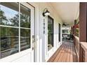 Inviting front porch featuring a wooden deck, craftsman door, and modern exterior lighting at 1998 Shalimar Ne Dr, Atlanta, GA 30345