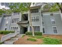Three-story residential building with light gray siding and stairway access at 211 Summit North Drive Ne, Atlanta, GA 30324