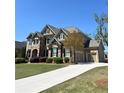 Beautiful two-story home featuring a three-car garage and a well-maintained lawn in a suburban neighborhood at 2671 Moon Chase Ln, Buford, GA 30519