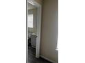 Bright bathroom featuring modern gray vanity, seen through doorway at 4071 River Rd, Ellenwood, GA 30294