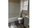 Clean, bright bathroom with a combined shower and tub, and gray vanity at 4071 River Rd, Ellenwood, GA 30294