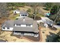 Aerial view of a home with a pool, detached garage, and mature trees on a large lot at 813 Sandy Creek Rd, Fayetteville, GA 30214