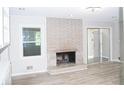 Bright living room with brick fireplace and updated flooring at 1584 Hebron Ln, Riverdale, GA 30296