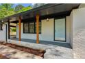 Inviting front porch with painted columns and a light blue front door at 4442 Mark Anthony Ct, Decatur, GA 30035