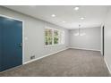 Neutral living room featuring plush carpet, lots of natural light, and a modern light fixture at 4442 Mark Anthony Ct, Decatur, GA 30035
