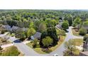 An aerial view of a neighborhood and landscaped yard with mature trees around a single-story home at 5755 Haterleigh Dr, Alpharetta, GA 30005