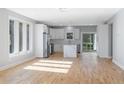 Bright and spacious living area featuring hardwood floors and a modern design, leading into a white kitchen at 2195 Springdale Sw Rd, Atlanta, GA 30315