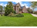 Spacious front yard with a well-maintained lawn and manicured landscaping leading to a brick home at 5204 Heron Bay Blvd, Locust Grove, GA 30248