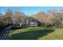 Classic brick home with a columned front porch and mature trees, set on a sprawling green lawn at 5254 Franklin Goldmine Rd, Cumming, GA 30028