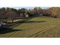 Expansive acreage view showcasing the beautiful estate, fenced pasture, and mature trees at 5254 Franklin Goldmine Rd, Cumming, GA 30028