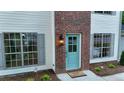 Welcoming front entrance with a brick accent, blue door, and a 'hello' doormat at 5728 Norman Ct, Atlanta, GA 30349