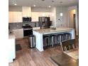 Open concept kitchen with an island, stainless steel appliances and pendant lighting at 860 Point Place Dr, Loganville, GA 30052