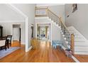 Bright foyer with hardwood floors, staircase with iron spindles, and views to other rooms at 105 Grogans Lake Dr, Atlanta, GA 30350