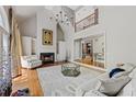 Bright living room featuring a fireplace, large windows, and an open view to the upper level at 105 Grogans Lake Dr, Atlanta, GA 30350