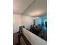 Dining room showcasing a full wall mirror, table and chandelier at 6851 Roswell Rd # O10, Atlanta, GA 30328