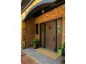 Close up of a custom wood double front door flanked by sidelights, brick facade, stone accents, and potted plants at 2015 N Decatur Ne Rd, Atlanta, GA 30307
