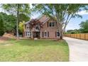 Beautiful brick home with a well-maintained lawn and a long driveway leading to the property at 5300 Coacoochee Ter, Johns Creek, GA 30022