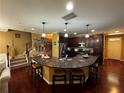 Open kitchen with a granite countertop island, stainless steel appliances, and hardwood floors at 1598 Lenox Overlook Ne Rd, Atlanta, GA 30329