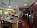 Open kitchen with island, granite countertops, stainless appliances, and adjacent living spaces at 1598 Lenox Overlook Ne Rd, Atlanta, GA 30329
