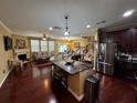 Open concept living area with hardwood floors, a kitchen island, and a cozy fireplace at 1598 Lenox Overlook Ne Rd, Atlanta, GA 30329