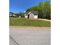 Scenic property showcases a well-kept lawn, inviting curb appeal, and ample space at 305 Pleasant Forest Dr, Temple, GA 30179